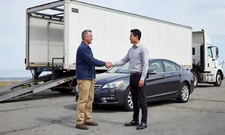 Vehicle owner beside their delivered car in Chepachet, Rhode Island, United States