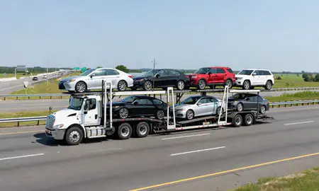 Multi-level car carrier on the highway to Cranston, Rhode Island, United States
