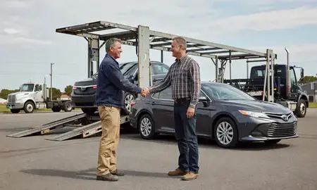 Vehicle owner beside their delivered car in Foster Center, Rhode Island, United States