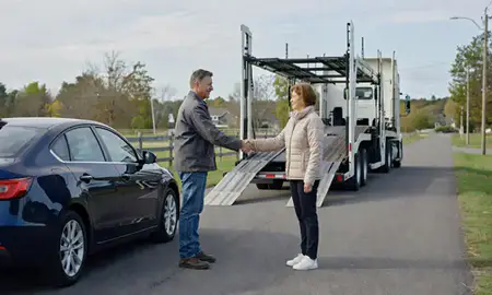 Vehicle owner beside their delivered car in Greene, Rhode Island, United States