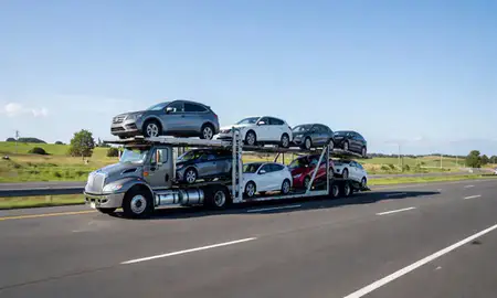 Multi-level car carrier on the highway to Kingston, Rhode Island, United States