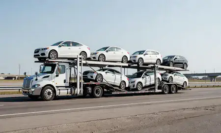Multi-level car carrier on the highway to Melville, Rhode Island, United States