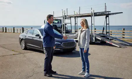 Vehicle owner beside their delivered car in Narragansett Pier, Rhode Island, United States