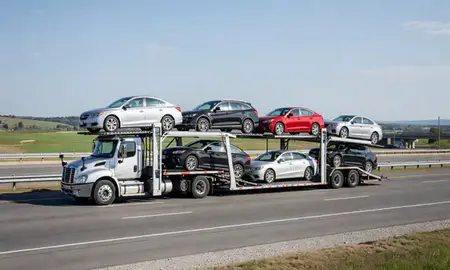 Multi-level car carrier on the highway to Newport East, Rhode Island, United States