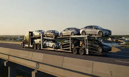 Car transporter with the Pascoag, Rhode Island, United States skyline behind it