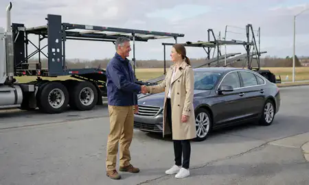Vehicle owner beside their delivered car in Quonochontaug, Rhode Island, United States