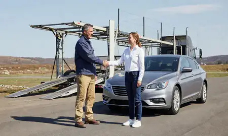 Vehicle owner beside their delivered car in Wyoming, Rhode Island, United States