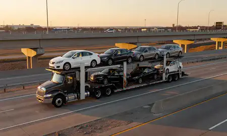 Car transporter with the Greer, South Carolina, United States skyline behind it