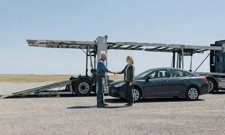 Vehicle owner beside their delivered car in South Dakota, United States