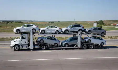 Multi-level car carrier on the highway to Blackhawk, South Dakota, United States