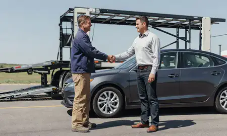 Vehicle owner beside their delivered car in Box Elder, South Dakota, United States