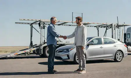 Vehicle owner beside their delivered car in Brookings, South Dakota, United States