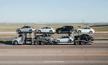 Multi-level car carrier on the highway to Canton, South Dakota, United States