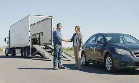 Vehicle owner beside their delivered car in Canton, South Dakota, United States