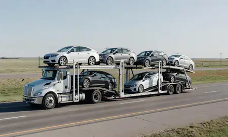 Multi-level car carrier on the highway to Dell Rapids, South Dakota, United States