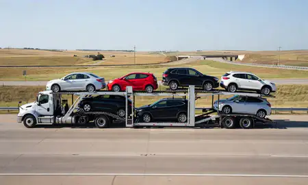 Multi-level car carrier on the highway to Harrisburg, South Dakota, United States