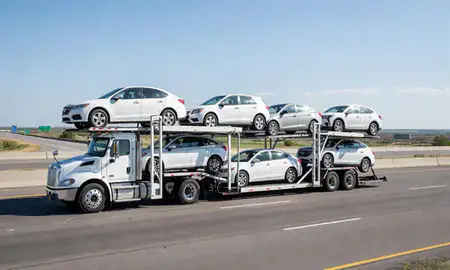Multi-level car carrier on the highway to Hartford, South Dakota, United States