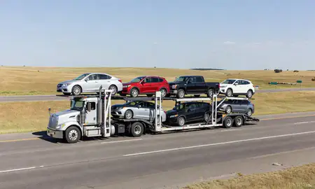 Multi-level car carrier on the highway to Hot Springs, South Dakota, United States
