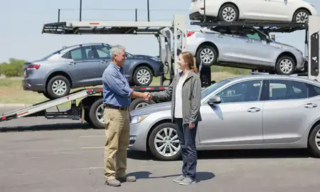 Vehicle owner beside their delivered car in Hot Springs, South Dakota, United States