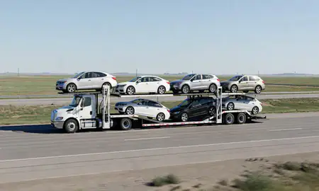 Multi-level car carrier on the highway to Huron, South Dakota, United States