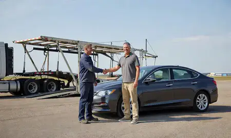 Vehicle owner beside their delivered car in Huron, South Dakota, United States