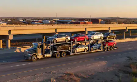 Car transporter with the Huron, South Dakota, United States skyline behind it