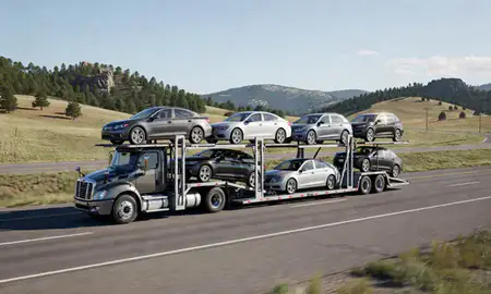 Multi-level car carrier on the highway to Lead, South Dakota, United States