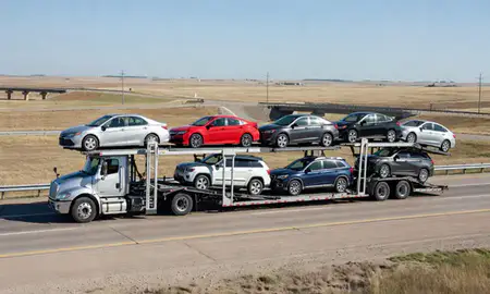 Multi-level car carrier on the highway to Mitchell, South Dakota, United States