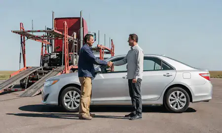 Vehicle owner beside their delivered car in Mobridge, South Dakota, United States