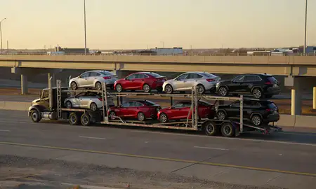 Car transporter with the Mobridge, South Dakota, United States skyline behind it