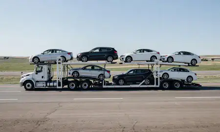 Multi-level car carrier on the highway to Pierre, South Dakota, United States