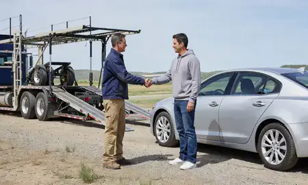 Vehicle owner beside their delivered car in Rapid Valley, South Dakota, United States