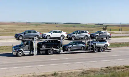 Multi-level car carrier on the highway to Summerset, South Dakota, United States