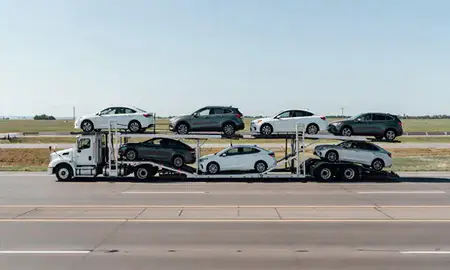 Multi-level car carrier on the highway to Tea, South Dakota, United States