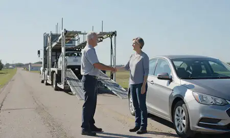 Vehicle owner beside their delivered car in Tea, South Dakota, United States