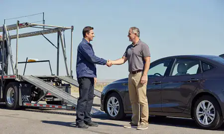 Vehicle owner beside their delivered car in Watertown, South Dakota, United States