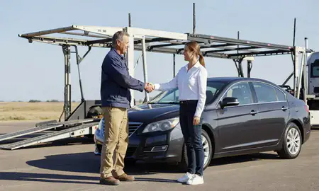 Vehicle owner beside their delivered car in Yankton, South Dakota, United States