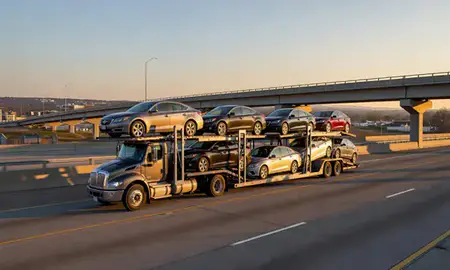 Car transporter with the Farragut, Tennessee, United States skyline behind it