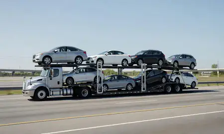 Multi-level car carrier on the highway to Memphis, Tennessee, United States