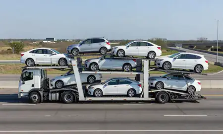 Multi-level car carrier on the highway to Arlington, Texas, United States