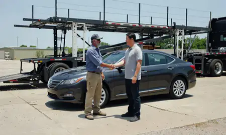 Vehicle owner beside their delivered car in Beaumont, Texas, United States