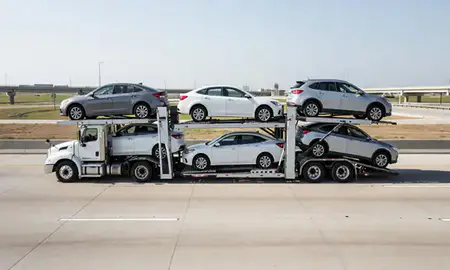 Multi-level car carrier on the highway to Dallas, Texas, United States