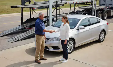 Vehicle owner beside their delivered car in Grand Prairie, Texas, United States