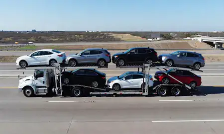 Multi-level car carrier on the highway to Laredo, Texas, United States