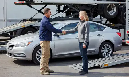 Vehicle owner beside their delivered car in Logan, Utah, United States