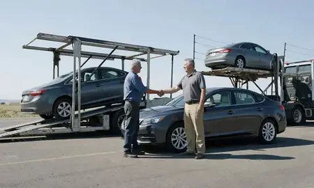Vehicle owner beside their delivered car in Roy, Utah, United States
