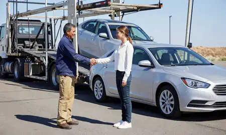 Vehicle owner beside their delivered car in Sandy, Utah, United States