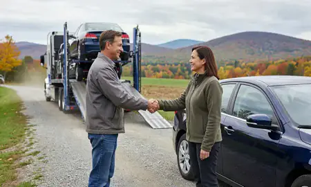 Vehicle owner beside their delivered car in Vermont, United States