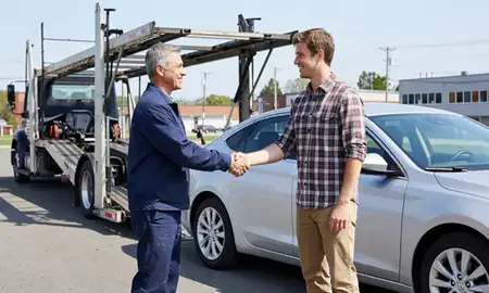 Vehicle owner beside their delivered car in Barre, Vermont, United States