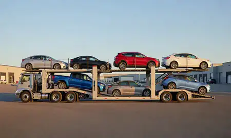 Car transporter parked in an industrial area of Bellows Falls, Vermont, United States